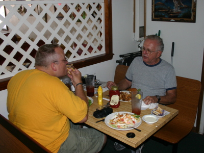 Tom N2UHC and Joe W0MQY enjoying a nice visit over lunch.  The empty seat belongs to Dave W0CH